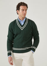 Men's racing green cricket jumper with a vee neck and ecru trim.