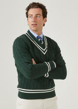 Men's racing green cricket jumper with a vee neck and ecru trim.