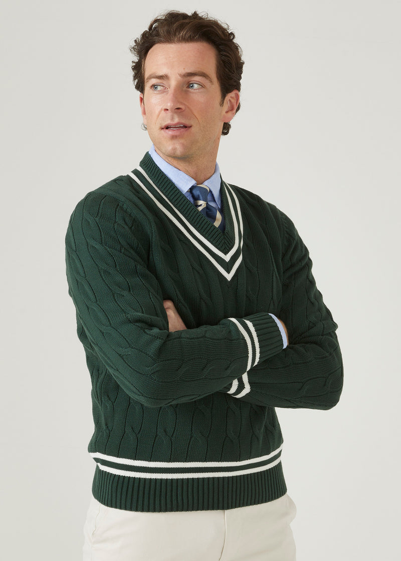 Men's racing green cricket jumper with a vee neck and ecru trim.