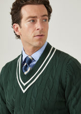 Men's racing green cricket jumper with a vee neck and ecru trim.